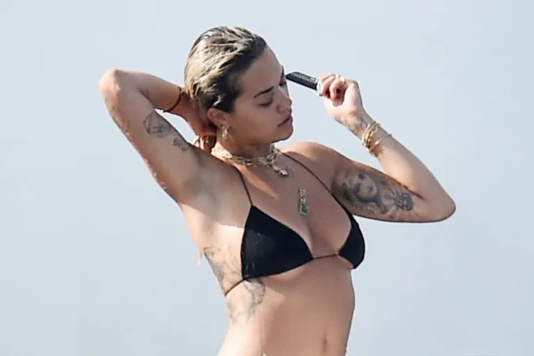 EXCLUSIVE: Singer Rita Ora spotted wearing a black bikini on holiday in Sardinia