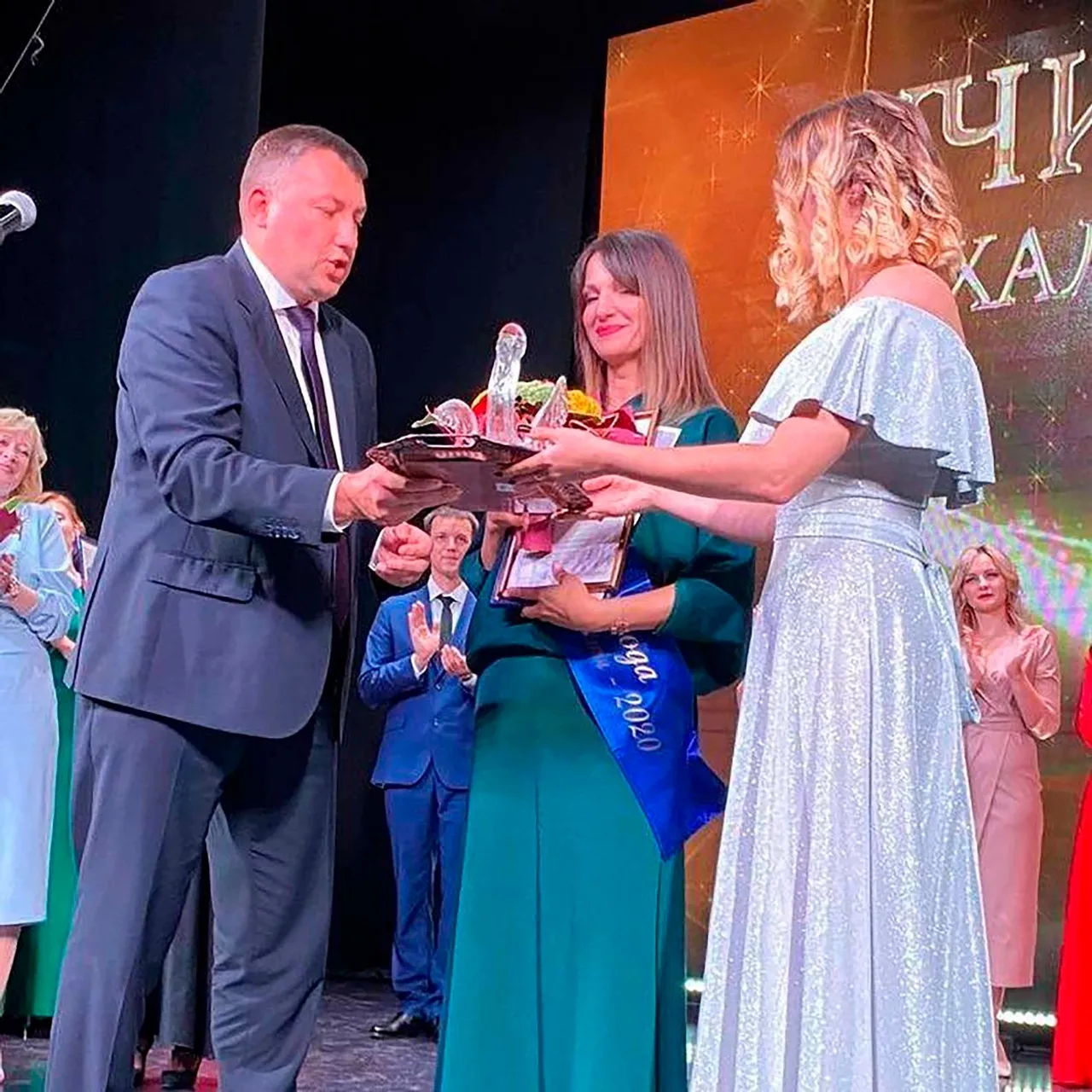 Women teachers face embarrassment after footage leaks of them enthusiastically touching a phallic-like glass pelican trophy