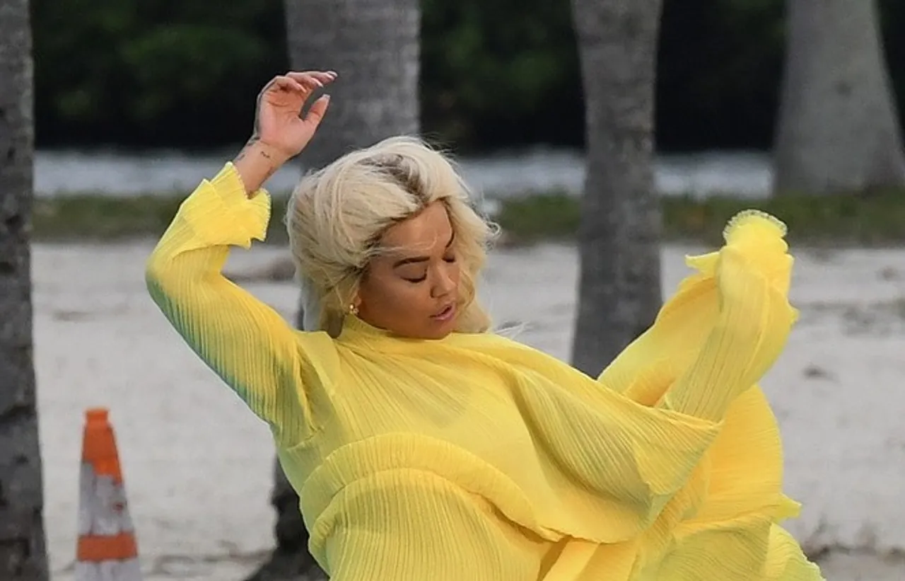 Singer Rita Ora has a wardrobe malfunction in a high cut yellow dress as she dances on a floating platform while filming a commercial for Diechmann Shoes in Miami