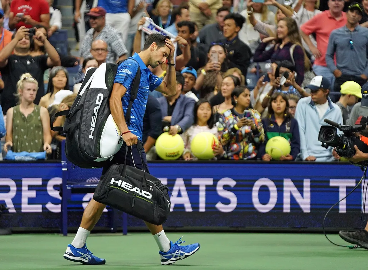 Stan Wawrinka and Novak Djokovic embrace after Djokovic retired from his match at the 2019 US Open