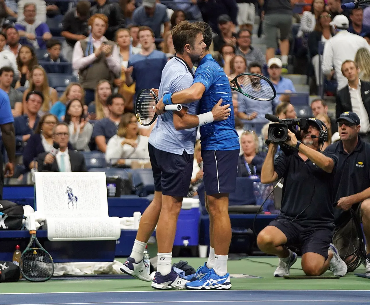 Stan Wawrinka and Novak Djokovic embrace after Djokovic retired from his match at the 2019 US Open
